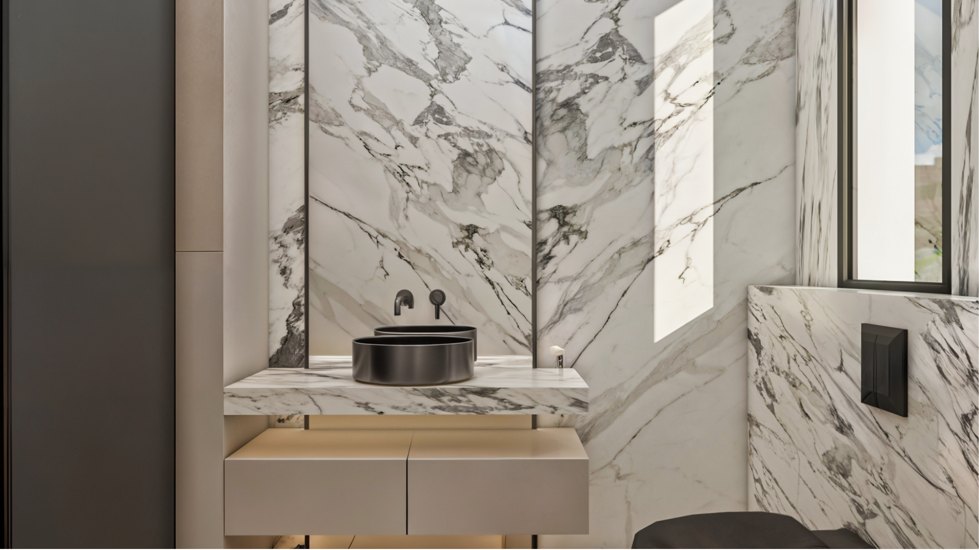 Modern bathroom design at Achakar Gardens with marble wall finishes, integrated vanity, and refined minimalist detailing.